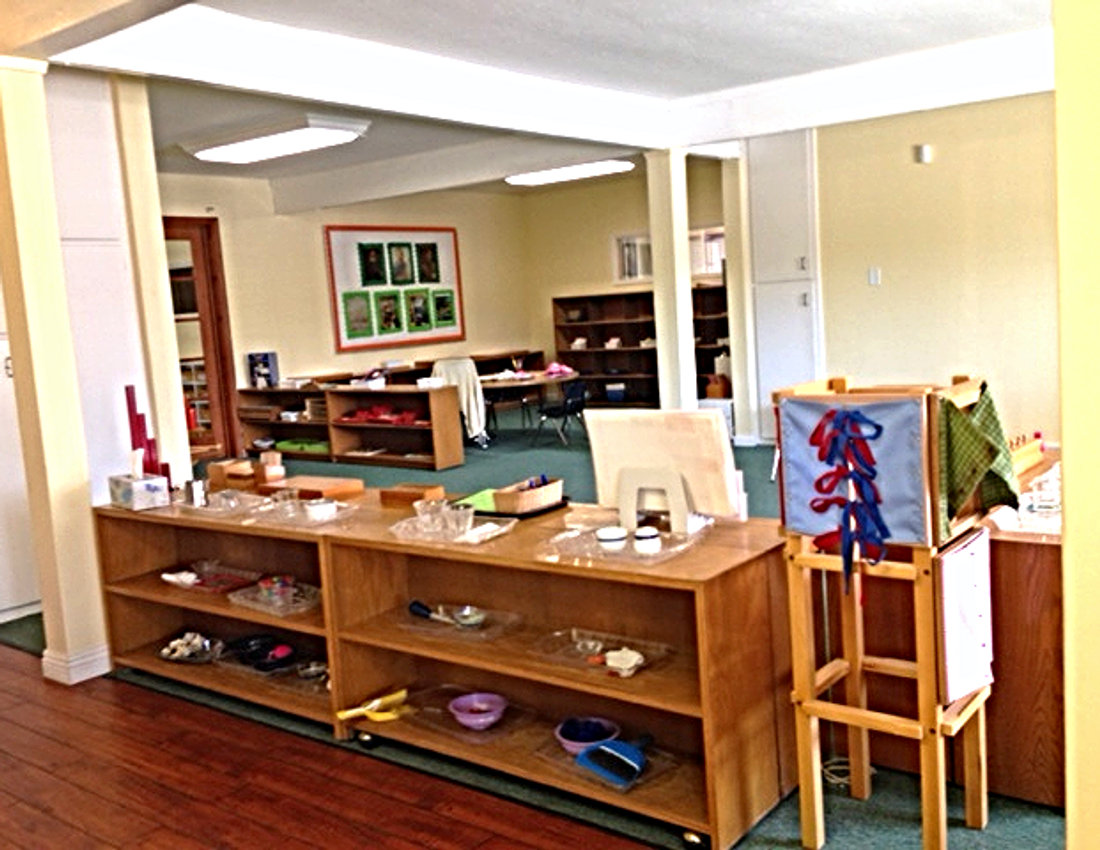 Inside a Carlsbad Village Montessori classroom, with wooden shelves of hands-on learning materials