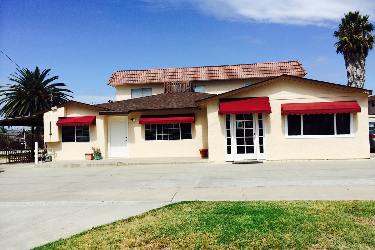 The Carlsbad Village Montessori School building at 740 Pine Avenue, with red awnings